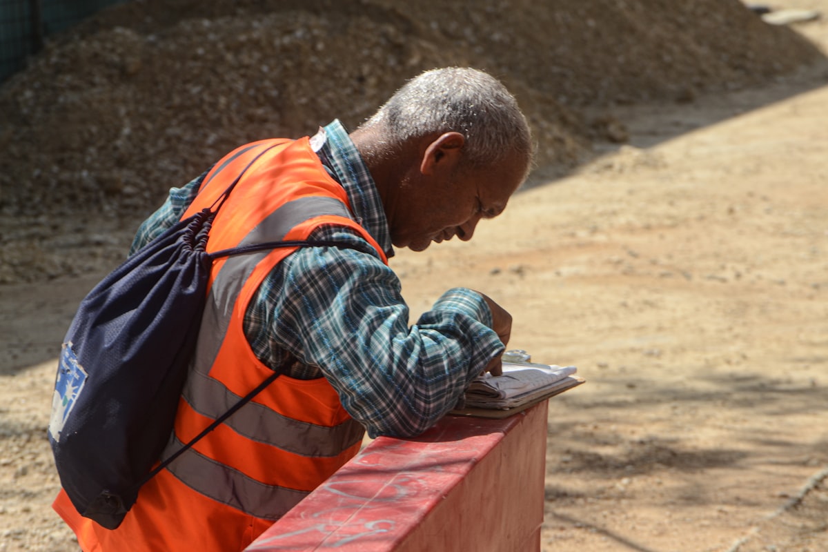 Site foreman reviewing CIS documentation at a construction project